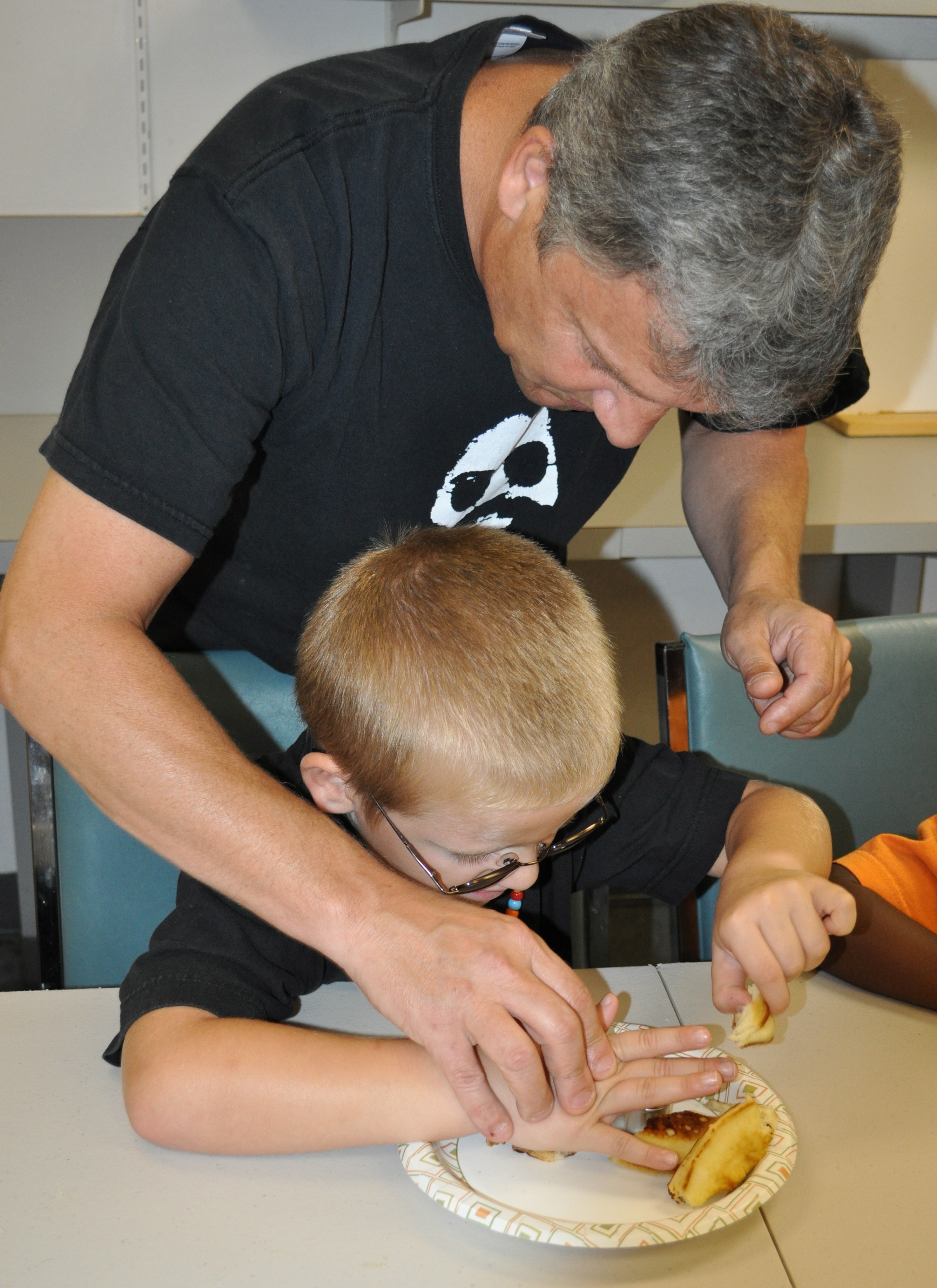 A Teacher of Students with Visual Impairments and student making a sandwich